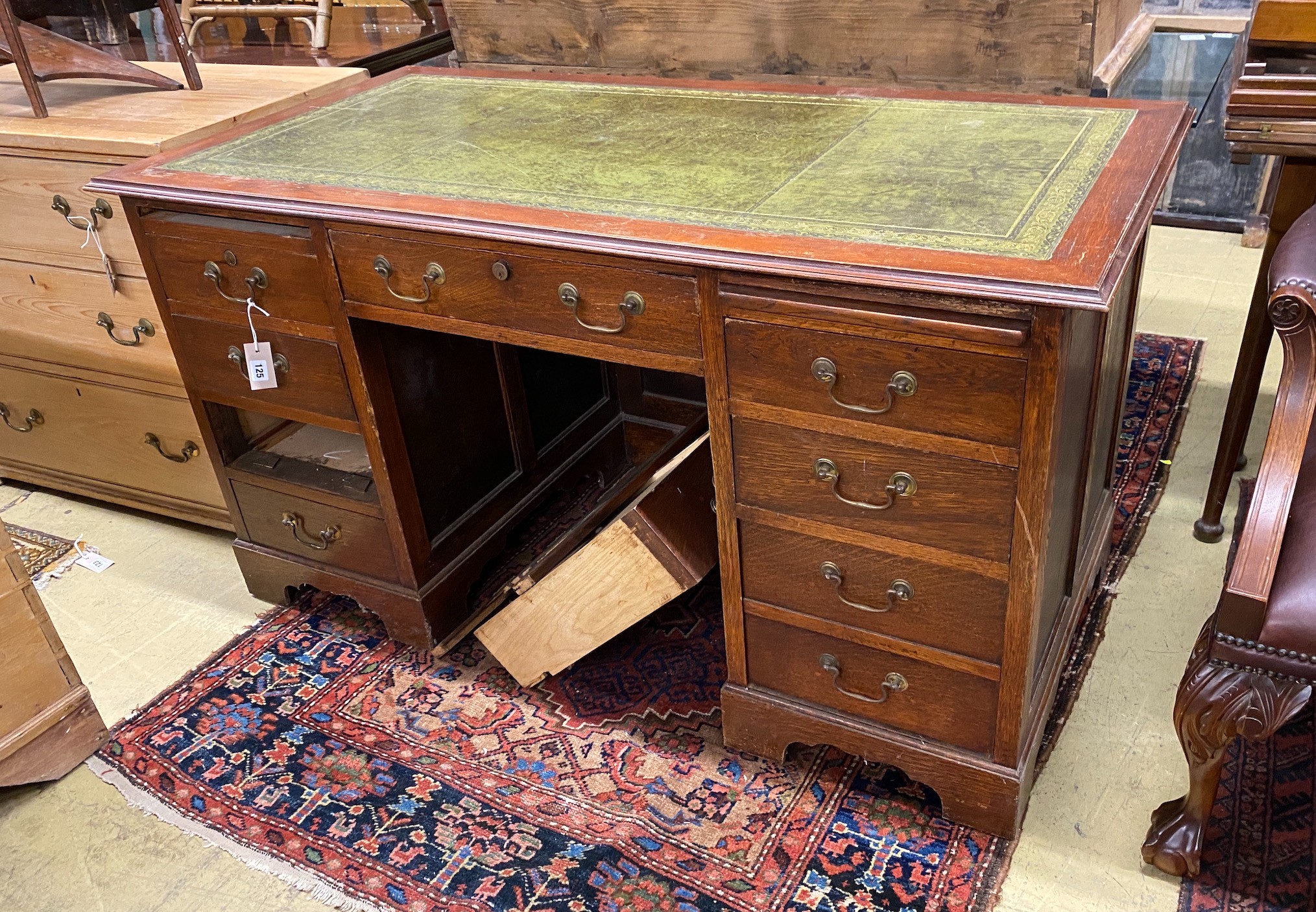 An early 20th century oak kneehole desk, length 141cm, depth 72cm, height 76cm